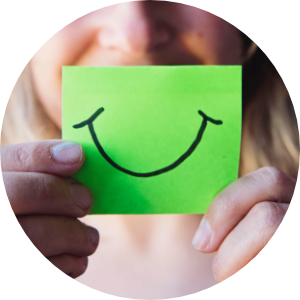 woman holding up smiley face mouth on a post it